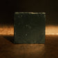 Black bar soap on brown background