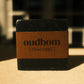 Bar of black soap with a brown label, “oudbom, charcoal”